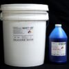 White plastic bucket labeled "44 lb Kit : Soft 107 – (7 shore A durometer) – Longer Pot Life Mold Making Silicone" next to a blue bottle of "cat blue solution catalyst" against a black background.