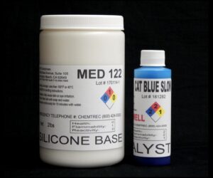 Two chemical containers on a black background, one large white labeled "2 lb Kit : Medium 122 – (22 shore A durometer) – Longer Pot Life Mold Making Silicone" and a smaller blue one labeled "cat blue slow catalyst".