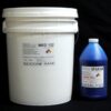 A white plastic bucket labeled "44 lb Kit : Medium 122 – (22 shore A durometer) – Longer Pot Life Mold Making Silicone" next to a blue bottle labeled "cat blue son catalyst" against a black background.