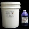 A white plastic bucket labeled "44 lb Kit : Medium 122 – (22 shore A durometer) – Regular Pot Life Mold Making Silicone" next to a purple bottle of catalyst marked "shake well." both items are displayed against a black background.