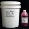 A white industrial bucket labeled "44 lb Kit : Medium 122 – (22 shore A durometer) – Fast Curing Mold Making Silicone" next to a pink bottle labeled "cat red fast catalyst" against a black background.