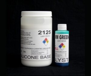 Two containers against a black background, one large white labeled "silicone base" and a smaller blue labeled "catalyst". both display hazard symbols and product information.