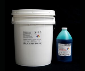 White bucket labeled "44 lb Kit : #2125 Base w/ MM Green Catalyst – (25 shore a durometer)" and a blue bottle labeled "catalyst" on a black background.