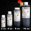 Four bottles of 16 oz Black Catalyst ink aligned in increasing order, against a black background.