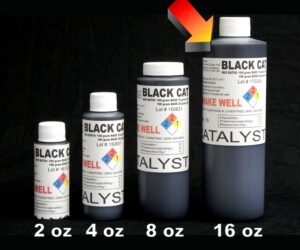 Four bottles of 16 oz Black Catalyst ink aligned in increasing order, against a black background.