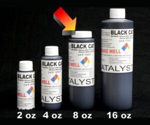 Four bottles of 8 oz Black Catalyst tattoo ink in different sizes—2 oz, 4 oz, 8 oz, 16 oz—arranged in ascending order against a black background.