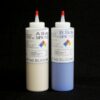 Two bottles of 2 lb kit MPK 1125 Duplicating Silicone, one white and the other blue, against a black background.