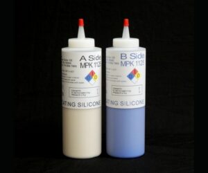 Two bottles of 2 lb kit MPK 1125 Duplicating Silicone, one white and the other blue, against a black background.