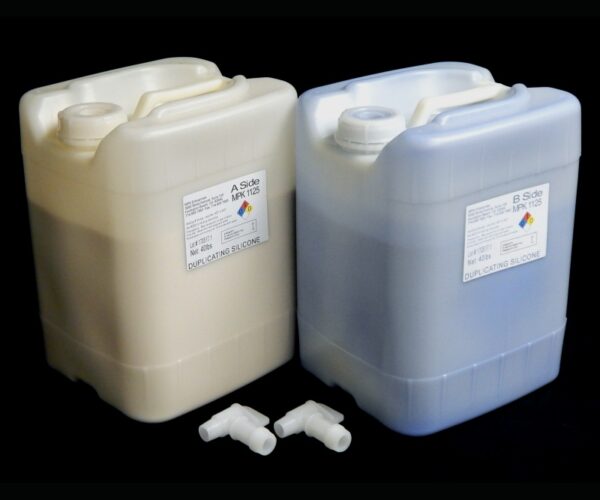 Two large plastic jerrycans labeled a and b, each with a dispensing pump, used for storing and dispensing 80 lb Kit MPK 1125 Duplicating Silicone packaged in pourable jugs with faucets.