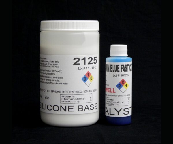 Two containers against a black background: a large white container labeled "2 lb Kit : #2125 Base" and a smaller blue container labeled "MM Blue Fast Catalyst (25 shore A durometer).