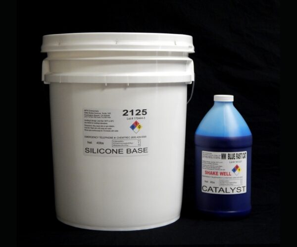 A white plastic bucket labeled "44 lb Kit : #2125 Base w/ MM Blue Fast Catalyst (25 shore A durometer)" next to a blue plastic bottle labeled "catalyst" against a black background.