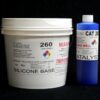 A large white bucket labeled "11 lb Kit : Food Grade QM 260 FG B : 60 shore A – Platinum Silicone" next to a blue cylindrical container labeled "Blue Catalyst" against a black background.