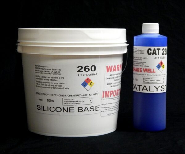 A large white bucket labeled "11 lb Kit : Food Grade QM 260 FG B : 60 shore A – Platinum Silicone" next to a blue cylindrical container labeled "Blue Catalyst" against a black background.