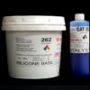 A white plastic bucket labeled "11 lb Kit : QM 262 : 62 shore A – Platinum Silicone" next to a blue and white spray can labeled "catalyst" on a black background.