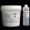 A white plastic bucket labeled "11 lb Kit : QM 280 : 80 shore A – Platinum Silicone" and a tube marked "catalyst" on a black background.