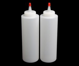 Two 16 oz bottles with red caps on a black background.