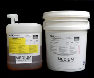 Two large containers of 5 Gal Kit (55 lb) MPK-301 : 6 lb Medium Pour Foam (15 lb A and 40 lb B), labeled with safety and product information, against a black background.