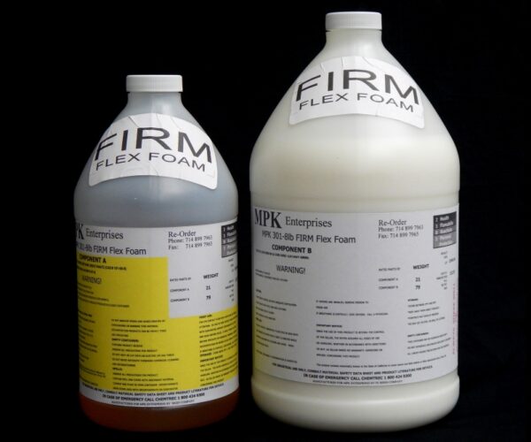 Two large industrial bottles labeled "1 Gal Kit (11.5 lb) : MPK-301 : 8 lb Firm Pour Foam – (3.5 lb A and 8 lb B)," one white and one beige, against a black background, each with detailed product and safety information.