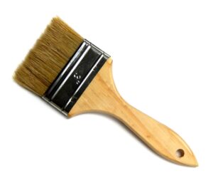 A wooden brush with a black handle