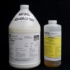 Two 1 Gallon Kit MPK 400-40A-100sec NATURAL containers with labels, one large white jug and a smaller yellow bottle, against a black background.