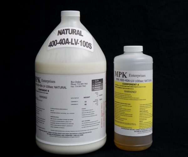 Two 1 Gallon Kit MPK 400-40A-100sec NATURAL containers with labels, one large white jug and a smaller yellow bottle, against a black background.