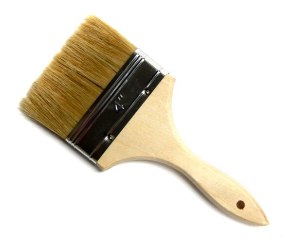 A wooden brush with brown bristles on top of it.