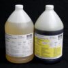 Two large industrial jugs labeled as 16 lb Kit MPK-70 : 5 Min Polyurethane Casting Resin, one filled with a tan liquid and the other with a blue liquid, against a black background.