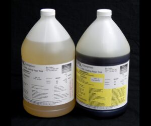 Two large industrial jugs labeled as 16 lb Kit MPK-70 : 5 Min Polyurethane Casting Resin, one filled with a tan liquid and the other with a blue liquid, against a black background.