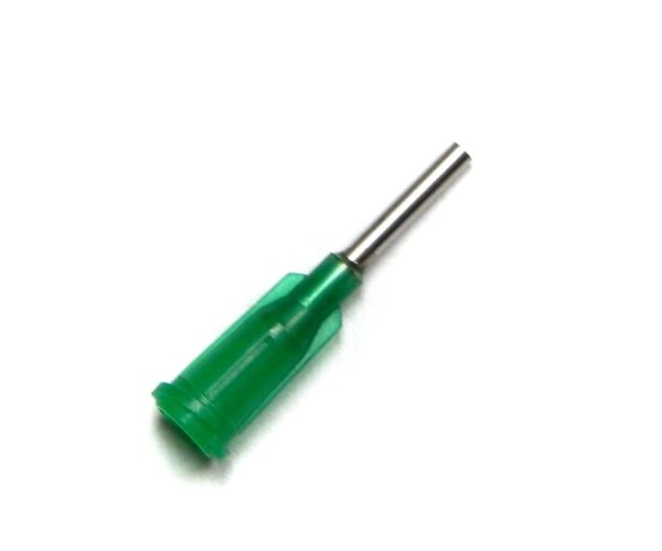 A green screwdriver is sitting on top of the floor.