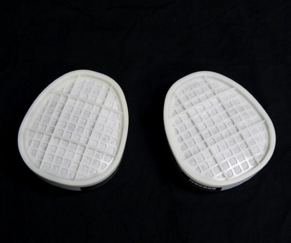 A pair of white pads sitting on top of a black surface.