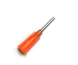 A orange screwdriver is sitting on top of the floor.