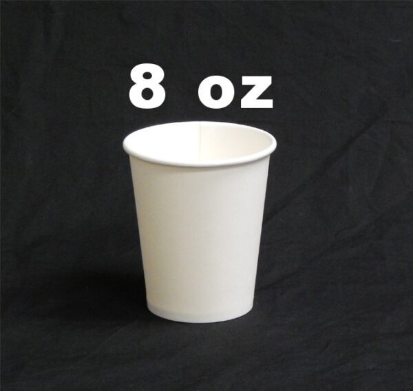 A white cup sitting on top of a black table.