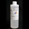 A white plastic bottle with a label showing chemical hazard information and the product name "1 lb/16 oz Kit Silicone Fluid".