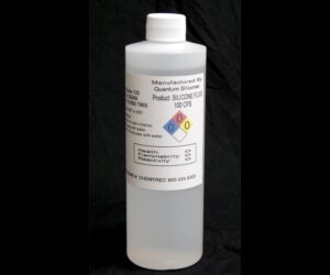 A white plastic bottle with a label showing chemical hazard information and the product name "1 lb/16 oz Kit Silicone Fluid".