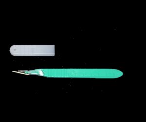 A #11-Blade Disposable Scalpel Qty 10 with a cap lying next to it on a black background.