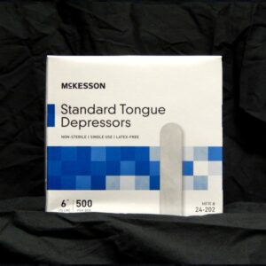 A box of tongue depressors sitting on top of a table.