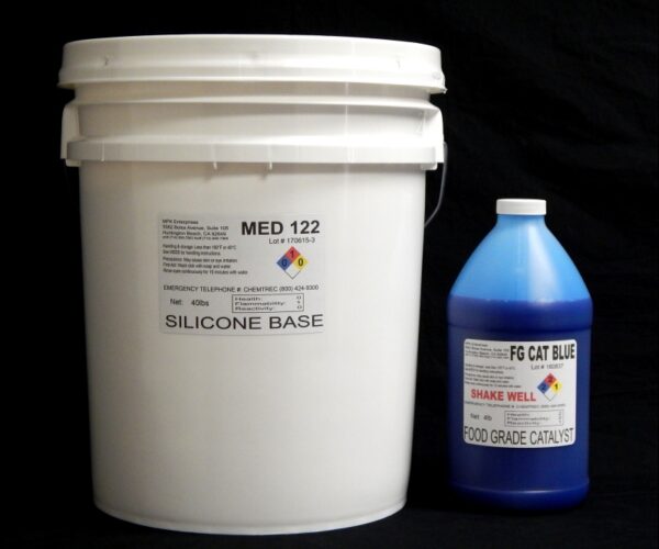 A white bucket labeled "44 lb Kit : Medium 122 FG Cat Blue" and a blue bottle labeled "(22 shore A durometer) – Food Grade Mold Making Silicone" on a black background.